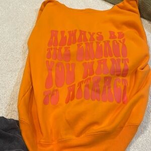 Orange zip up from pacsun with graphic writing on the back